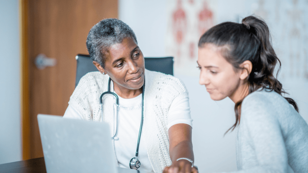 african american female doctor and female patient